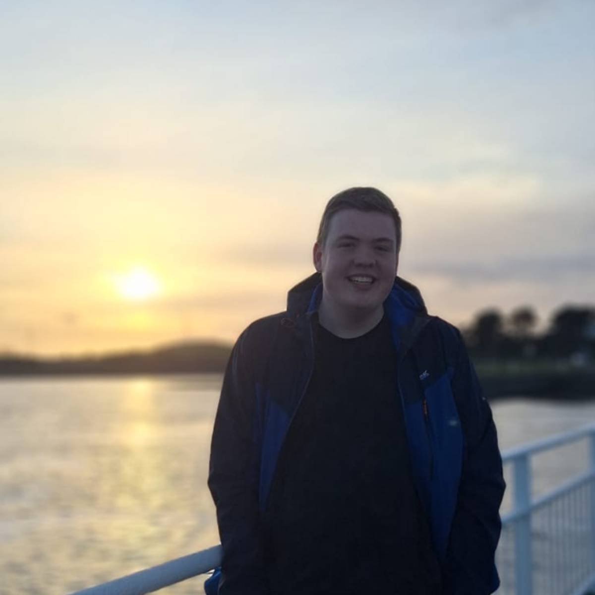 Cillian Gowen, founder of wobble, smiling at sunset